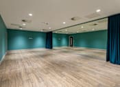 Thumbnail 19 of 36 - A room with wooden flooring and a glass wall.