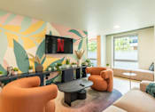 Thumbnail 3 of 25 - A living room with a TV displaying the Netflix logo.
