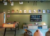 Thumbnail 14 of 35 - a games room with a pool table and a wall of framed pictures