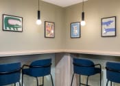 Thumbnail 6 of 20 - a conference room with blue chairs and pictures on the wall