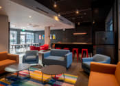 Thumbnail 4 of 18 - a lounge area with chairs and tables and a bar