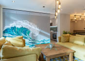 Thumbnail 8 of 15 - a living room with a large wall mural of a wave