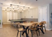 Thumbnail 5 of 15 - a conference room with tables and chairs and a ping pong table