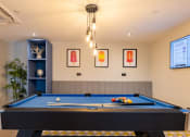 Thumbnail 1 of 15 - a games room with a pool table and a tv