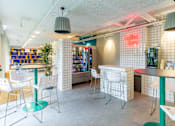 Thumbnail 3 of 51 - A room with a collection showcase and a bar area.