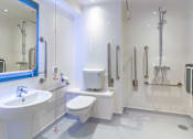 Thumbnail 48 of 51 - A white bathroom with a sink, toilet, and shower.