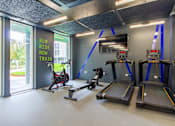 Thumbnail 26 of 51 - A gym with treadmills and a sign that says "Run, Ride, Row, Train".