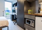 Thumbnail 42 of 51 - A modern kitchen with a built-in oven and microwave.