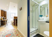 Thumbnail 19 of 21 - A bathroom with a white sink and a blue door.