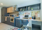 Thumbnail 9 of 35 - A modern kitchen with a grey and white color scheme.