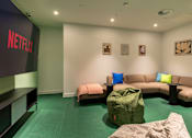 Thumbnail 10 of 29 - A Netflix branded room with a couch and bean bag chair.
