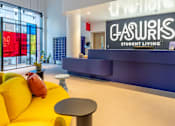 Thumbnail 13 of 29 - A bright yellow sofa sits in front of a sign that says Gasworks Student Living.