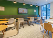 Thumbnail 12 of 29 - A room with green walls and wooden furniture.