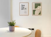 Thumbnail 11 of 29 - A white table with a plant on it and two framed pictures on the wall.