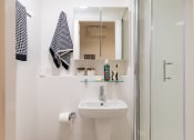 Thumbnail 27 of 29 - a small bathroom with a sink and a shower