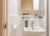 Thumbnail 28 of 29 - a small bathroom with a sink and a mirror