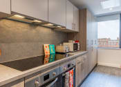 Thumbnail 20 of 29 - a kitchen with a counter top and a window