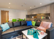 Thumbnail 22 of 29 - a living room with couches and a table with a chess board