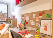 Thumbnail 19 of 29 - a home office with a desk and a bulletin board on the wall