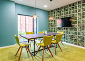 Thumbnail 4 of 19 - A dining room with a table and chairs.