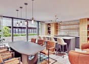 Thumbnail 6 of 17 - A modern dining room with a large table and chairs.