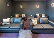 Thumbnail 30 of 30 - A row of grey couches with pillows on them.