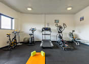 Thumbnail 7 of 30 - A gym room with a variety of exercise equipment.