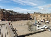 Thumbnail 11 of 13 - an aerial view of a town square with buildings and cars