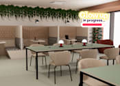 Thumbnail 5 of 21 - A conference room with a long table and chairs, a green plant, and a sign that says "Glow up in progress...".