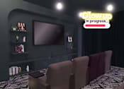 Thumbnail 7 of 21 - A room with a large screen and chairs with a sign that says "Glow up in progress...".