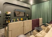Thumbnail 13 of 49 - A living room with a large couch and a painting on the wall.