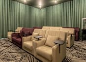 Thumbnail 14 of 49 - A row of beige and burgundy couches are lined up in a room with green curtains.