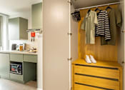 Thumbnail 37 of 49 - A small closet with a striped shirt hanging on it.