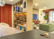 Thumbnail 11 of 49 - A living room with a grey table and a white sofa.