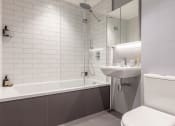 Thumbnail 9 of 37 - a small bathroom with a sink toilet and shower