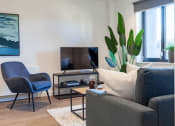 Thumbnail 6 of 37 - a living room with a couch chair and a television    and a plant