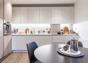 Thumbnail 21 of 37 - a kitchen with white cabinetry and a table and chairs