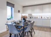 Thumbnail 27 of 37 - a kitchen and dining area with a table and chairs