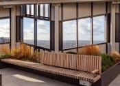 Thumbnail 30 of 37 - a bench in front of a row of windows