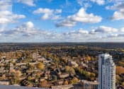 Thumbnail 29 of 37 - an aerial view of a city with a tall white skyscraper