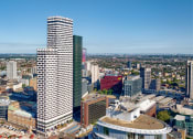 Thumbnail 1 of 37 - an aerial view of a city with a tall skyscraper