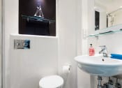 Thumbnail 8 of 39 - a bathroom with a toilet sink and mirror
