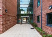 Thumbnail 39 of 39 - a walkway between two buildings with a large glass window