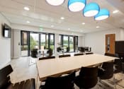 Thumbnail 3 of 39 - a meeting room with a large table and chairs