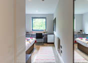 Thumbnail 17 of 39 - a bedroom with two beds and a desk