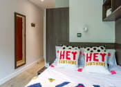 Thumbnail 18 of 39 - a bedroom with a bed and a mirror