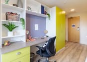 Thumbnail 17 of 50 - a desk with a chair in a room with a door in the background