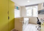 Thumbnail 31 of 50 - a room with a bed and a desk