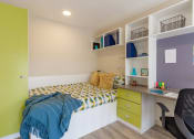 Thumbnail 40 of 50 - a bedroom with a bed and desk in a 555 waverly unit