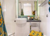 Thumbnail 42 of 50 - a bathroom with a sink and a mirror
